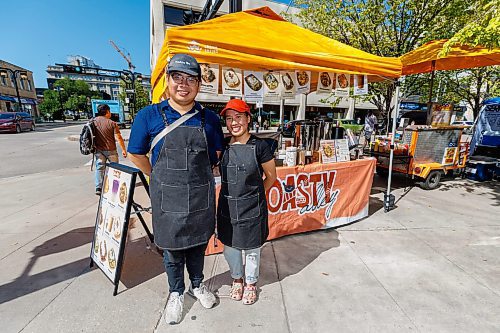 MIKE DEAL / FREE PRESS
Hannah Nguyen and Alain Pham at their station, Toasty Alley, a two-month old operation that sells croffles - a cross between croissants and waffles. The dish was created around 2018 in Korea, and has since spread around the world. Hannah and Alain (married) offer different flavours, including s'mores, pistachio and bacon-and-onions.
Reporter: Dave Sanderson
250828 - Thursday, August 28, 2025.