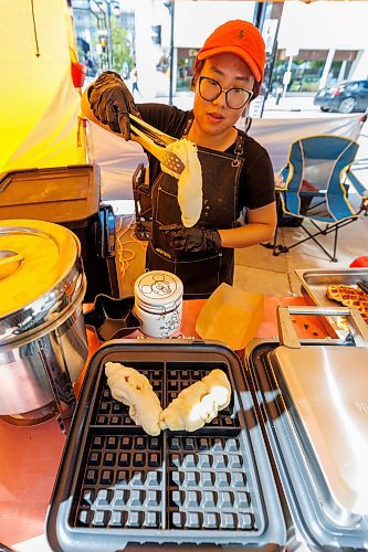 MIKE DEAL / FREE PRESS
Hannah Nguyen and Alain Pham at their station, Toasty Alley, a two-month old operation that sells croffles - a cross between croissants and waffles. The dish was created around 2018 in Korea, and has since spread around the world. Hannah and Alain (married) offer different flavours, including s'mores, pistachio and bacon-and-onions.
Reporter: Dave Sanderson
250828 - Thursday, August 28, 2025.