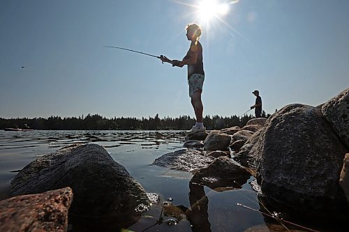 28082025
Zach Laramee and Ashton Wilson fish from the rocks at the end of the pier at the beach in Wasagaming on a hot and sunny Thursday afternoon.
(Tim Smith/The Brandon Sun)