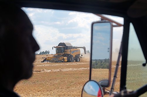 The silhouette of Norval Lee is seen as he drives a grain truck up to barley fields for harvest in Erickson. (Connor McDowell/The Brandon Sun)