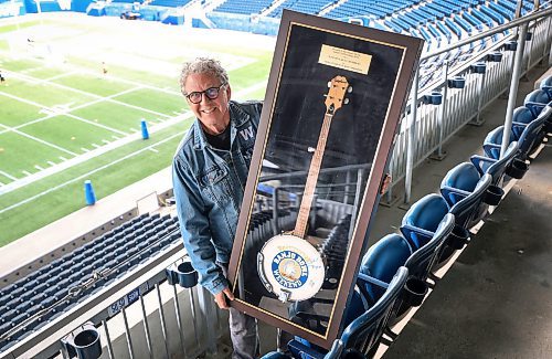 Ruth Bonneville / Free Press
LOCAL - Asper with Banjo Bowl
Photo of David Asper with encased banjo in his suite at Princess Auto Stadium.
Asper has the original Banjo Bowl trophy - an actual banjo - under glass.
Story about how David Asper is the person responsible for coining the game the Banjo Bowl, after kicker Troy Westwood's infamous remarks in the fall of '03)
Dave Sanderson, eature for Saturday,
history of the Banjo Bowl.
Sept 3rd,, 2025