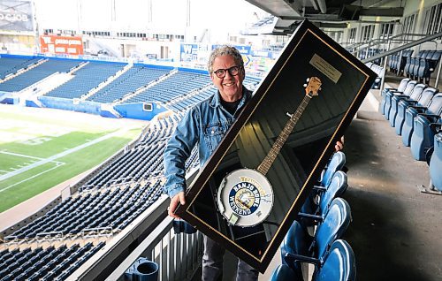 Ruth Bonneville / Free Press
LOCAL - Asper with Banjo Bowl
Photo of David Asper with encased banjo in his suite at Princess Auto Stadium.
Asper has the original Banjo Bowl trophy - an actual banjo - under glass.
Story about how David Asper is the person responsible for coining the game the Banjo Bowl, after kicker Troy Westwood's infamous remarks in the fall of '03)
Dave Sanderson, eature for Saturday,
history of the Banjo Bowl.
Sept 3rd,, 2025