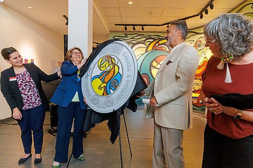 MIKE DEAL / FREE PRESS
An enlarged replica showcasing the art printed on the coin is unveiled by (from left) Dorota Blumczynska CEO of the Manitoba Museum, Marie Lemay CEO of the Royal Canadian Mint, Stan Somerville who is the son of artist Daphne Odjig, and Ginette Lavack, MP for St. Boniface-St. Vital and Parliamentary Secretary to the Minister of Indigenous Services.
The Royal Canadian Mint unveils a special two-dollar circulation coin recognizing artist, Daphne Odjig, and her contributions to the transformation of Indigenous art at a ceremony inside the Manitoba Museum in front of a mural she painted in 1972 titled, The Creation of the World.
250904 - Thursday, September 04, 2025.