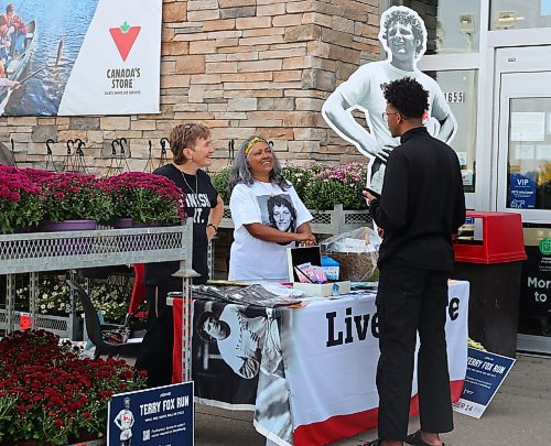 Heather Stewart (left) and Trish Toth, volunteers with the Terry Fox Foundation, answer questions from a man enquiring about this Sunday's Terry Fox Run. Stewart and Toth will be hosting this information booth outside the Brandon location of Canadian Tire each day this week from 1 to 6 p.m. (Michele McDougall/The Brandon Sun)