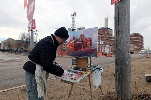 Weiming Zhao paints a downtown cityscape on Wednesday morning in Brandon. Zhao said the mild temperature following a rainfall made for a shimmering effect off the pavement, bleeding colour into the street from Brandon's red-brick downtown core. The painting — seen halfway done, at roughly the one-hour mark — was commissioned by a private citizen. (Connor McDowell/Brandon Sun)