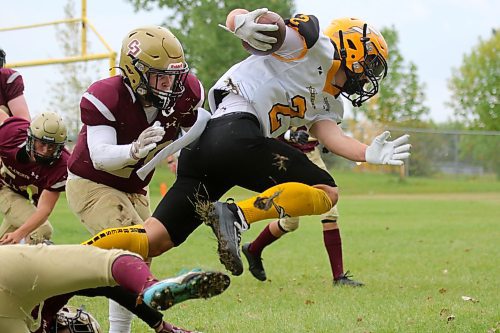 Crocus Plainsmen Easton Durgan, left, tackles Steinbach Sabres receiver Ryan Martin during their Winnipeg High School Football League AAAA Tier 1 game at Crocus on Thursday afternoon. (Thomas Friesen/The Brandon Sun)