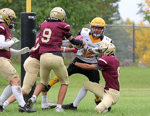 Steinbach Sabres running back Wade Anderson drags a swarm of Crocus Plainsmen with him into the end zone during their Winnipeg High School Football League AAAA Tier 1 game at Crocus on Thursday afternoon. (Thomas Friesen/The Brandon Sun)