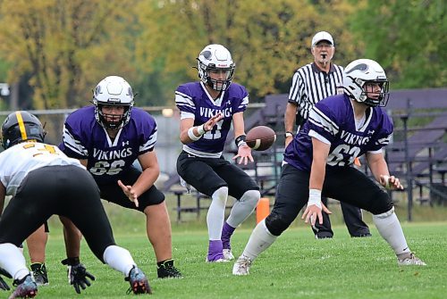 Vincent Massey Vikings offensive linemen Jack Ficek (66) and Grayden Clements (63) backpedal to block for quarterback Charlie Gauthier (11) during their Winnipeg High School Football League game at Doug Steeves Field on Thursday. (Thomas Friesen/The Brandon Sun)
