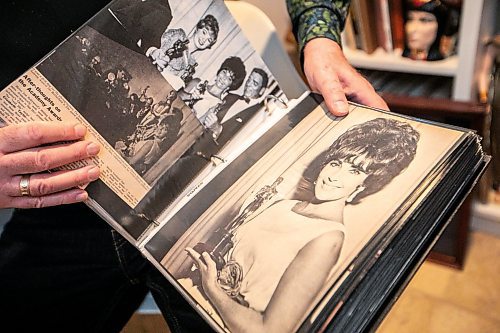 MIKAELA MACKENZIE / FREE PRESS

Hannon Bell opens one of the binders of Elizabeth Taylor memorabilia to a favourite photo on Tuesday, Sept. 9, 2025. He has over 120 three-ring binders filled with photos and news articles about the actress.

For Dave Sanderson story.
Free Press 2025