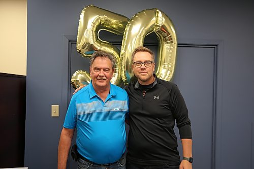 Left: Inventronics Limited product designer Jack Stewart takes a picture with the vice president (sales and marketing) Dan O’Greysik, shortly after the company paused operations for half an hour to recognize Stewatr's remarkable achievement on Friday morning. (Abiola Odutola/The Brandon Sun)