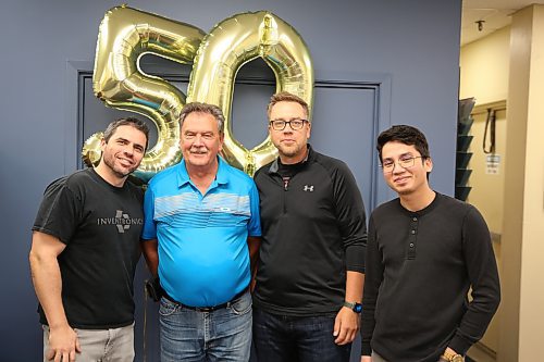 Inventronics staff Diogo Janiaski (from left), product designer Jack Stewart, vice-president of sales and marketing Dan O’Greysik and Harell Bayabay stand for a photo during a pause in operations to recognize Stewart's 50 years with the company on Friday. (Abiola Odutola/The Brandon Sun)