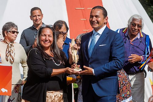 MIKE DEAL / FREE PRESS
Stephanie Scott, executive director, National Centre for Truth and Reconciliation gives a gift from the NCTR to the province, with Premier Wab Kinew accepting.
Premier Wab Kinew, minister responsible for Indigenous reconciliation, announces that his government will be putting forward $20 million to support the construction of a permanent home for the National Centre for Truth and Reconciliation (NCTR) at the University of Manitoba during a ceremony Friday afternoon where he also accepted a gift to the province from the NCTR, a bronze sculpture that depicts a single feather made by artist, Wayne Stranger, who is from Peguis First Nation.
Reporter: Niigaan Sinclair and Scott Billeck
250912 - Friday, September 12, 2025.