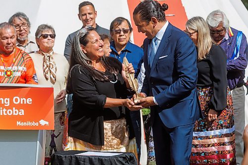 MIKE DEAL / FREE PRESS
Stephanie Scott, executive director, National Centre for Truth and Reconciliation gives a gift from the NCTR to the province, with Premier Wab Kinew accepting.
Premier Wab Kinew, minister responsible for Indigenous reconciliation, announces that his government will be putting forward $20 million to support the construction of a permanent home for the National Centre for Truth and Reconciliation (NCTR) at the University of Manitoba during a ceremony Friday afternoon where he also accepted a gift to the province from the NCTR, a bronze sculpture that depicts a single feather made by artist, Wayne Stranger, who is from Peguis First Nation.
Reporter: Niigaan Sinclair and Scott Billeck
250912 - Friday, September 12, 2025.