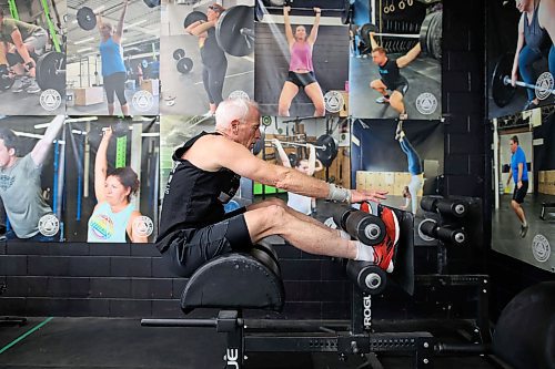Doug Murray works through a set of GHD situps during a training class at Rocked Community Fitness in Brandon on Tuesday. (Tim Smith/The Brandon Sun)