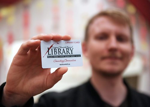 Holding a library card in his hands, Alex Rogowsky, manager of programming and community services for the Western Manitoba Regional Library encourages more area residents to sign up for library services. (Matt Goerzen/The Brandon Sun)