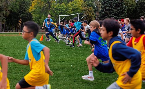 MIKE DEAL / FREE PRESS
Phys Ed teacher from Ecole St Avila, Dan Mitchell, waves a flag guiding grade six students who are taking part in a Pembina Trails Athletic Conference Cross Country Meet at St. Vital Park Wednesday afternoon. It&#x2019;s the first of a three meet series that students in grade 4-8 can take part in across the division. There are over 2,000 students that participate through out the race season in the Pembina Trails School Division.&#xa0;
Standup
250917 - Wednesday, September 17, 2025.