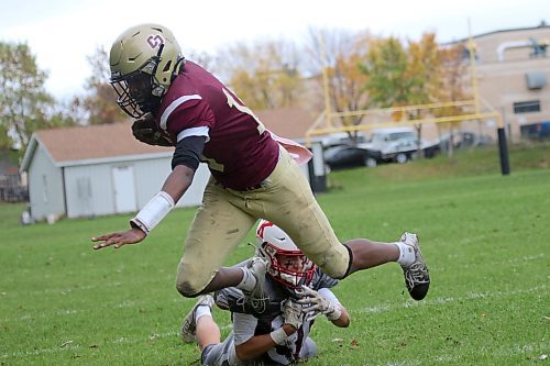 Crocus Plainsmen quarterback Joe Makori dives out of bounds against the Kelvin Clippers during their Winnipeg High School Football League game at Crocus on Thursday. (Thomas Friesen/The Brandon Sun)