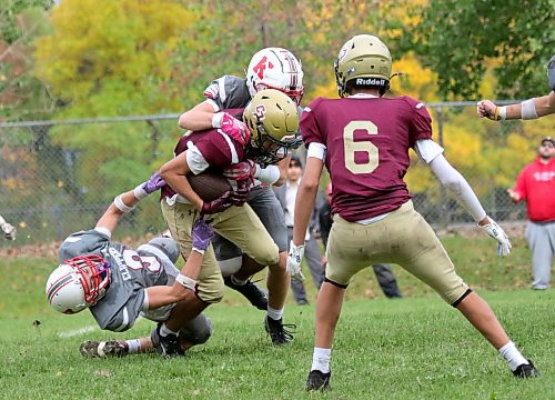 Crocus Plainsmen receiver Maurice Chartrand runs over Kelvin Clippers linebacker James Kreider during their Winnipeg High School Football League game at Crocus on Thursday. (Thomas Friesen/The Brandon Sun)