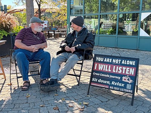 JOHN LONGHURST / FREE PRESS

Paul Jenkinson (left) listens to Maverick at The Forks on Friday. 
