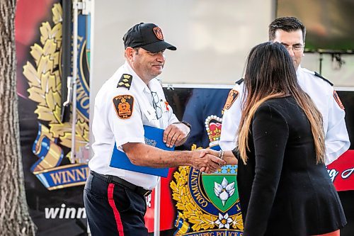 MIKAELA MACKENZIE / FREE PRESS

Chief Gene Bowers shakes hands with Winnipeg Police Service Indigenous relations advisor Sheila North at the Winnipeg Police Service sacred fire lighting celebration on Monday, Sept. 29, 2025. 

For Tyler story.
Free Press 2025