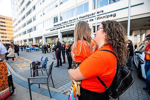MIKAELA MACKENZIE / FREE PRESS

Andrea Gallagher (director of Indigenous and community relations at Manitoba Justice) holds her daughter, Katherine Courteau, three (and granddaughter of both a residential school survivor and a police officer), at the Winnipeg Police Service sacred fire lighting celebration on Monday, Sept. 29, 2025. 

For Tyler story.
Free Press 2025