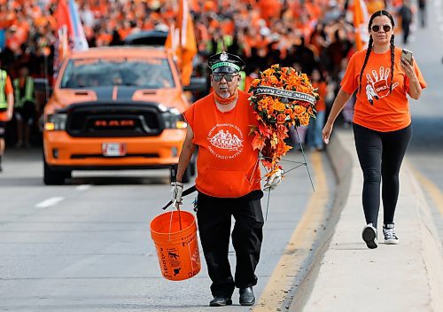 JOHN WOODS / FREE PRESS
Lawrence Douglas Corbiere carries a wreath as people take part in the Orange Shirt Healing Walk and Powwow in Winnipeg Tuesday, September 30, 2025. 

Reporter: malak