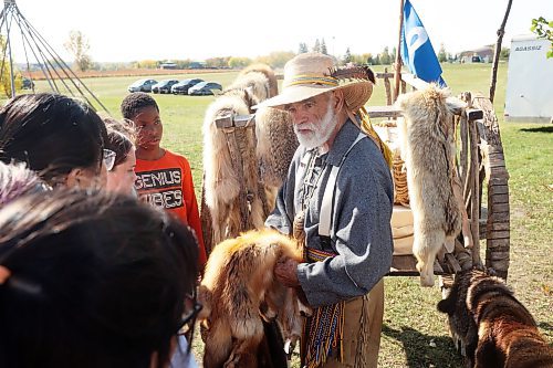 Grade 5 students from Waverly Park School listen as Métis educator Grant Armstrong talks about the differences between various furs at the Discovery Centre on Wednesday. (Tim Smith/The Brandon Sun)