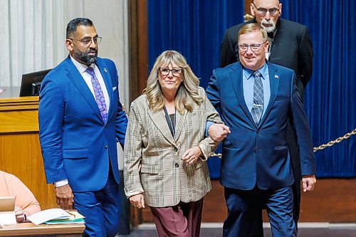 Newly elected PC MLA Colleen Robbins (Spruce Woods) is led to the Speaker for the traditional introduction by the PC House leader, MLA Derek Johnson (right), and PC party Leader Obby Khan (left) on her first Question Period during the first day of the second session of the 43rd legislature on Wednesday afternoon. (Mike Deal/Winnipeg Free Press)