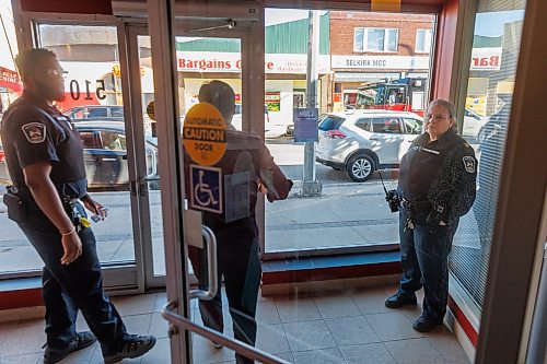 MIKE DEAL / FREE PRESS
Two officers with the provincial protective services wait for Minister Fontaine to leave 510 Selkirk Street which will be the location of Mino&#x2019;Ayaawag Ikwewag Lodge.
Families Minister Nahanni Fontaine, minister responsible for women and gender equity announces that the Manitoba government will providing $3.5 million to Ikwe Widdjiitiwin Inc. to establish a first-of-its-kind 24-7 safe space for Indigenous women in Winnipeg.
The announcement took place at the future home of Mino&#x2019;Ayaawag Ikwewag Lodge, 510 Selkirk Avenue.
The lodge will provide immediate, short-term safety and stabilization for Indigenous women at risk of violence, homelessness or exploitation. It will provide low-barrier access to culturally safe crisis support.
Reporter: Tyler Searle
251002 - Thursday, October 02, 2025.