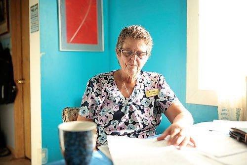 02102025
Pattie Cunningham looks over documents at the home she shares with her foster daughter Zoey Cunningham in Souris on Thursday.
(Tim Smith/The Brandon Sun)