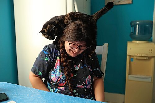 02102025
Eighteen-year-old Zoey Cunningham visits with her cat Lola at the home she shares with her foster mom Pattie Cunningham in Souris on Thursday.
(Tim Smith/The Brandon Sun)