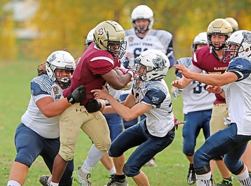 03102025
Muqtadir Apena #1 of the Crocus Plainsmen tries to break through a group of Grant Park Pirates players during high school football action at CPRSS on Friday afternoon. 
(Tim Smith/The Brandon Sun)