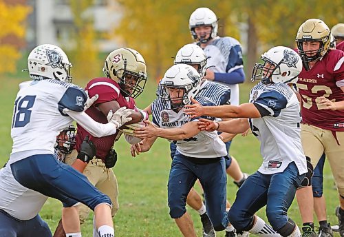 03102025
Muqtadir Apena #1 of the Crocus Plainsmen tries to break through a group of Grant Park Pirates players during high school football action at CPRSS on Friday afternoon. 
(Tim Smith/The Brandon Sun)