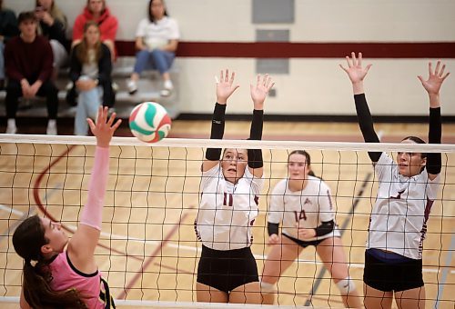 03102025
Tyra Lasuik #11 and Heather Brost #3 of the Assiniboine College Cougars leap to block the ball during the Cougars exhibition match against Briercrest College at AC on Friday evening. 
(Tim Smith/The Brandon Sun)