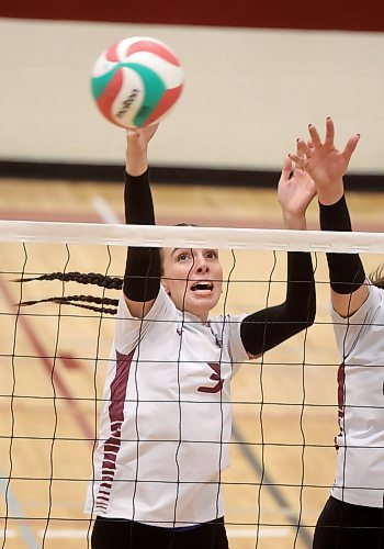 03102025
Heather Brost #3 of the Assiniboine College Cougars leaps to block the ball during the Cougars exhibition match against Briercrest College at AC on Friday evening. 
(Tim Smith/The Brandon Sun)