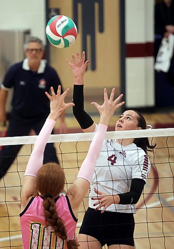 03102025
Kylee Peake #4 of the Assiniboine College Cougars leaps to put the ball over the net during an exhibition match against Briercrest College at AC on Friday evening. 
(Tim Smith/The Brandon Sun)