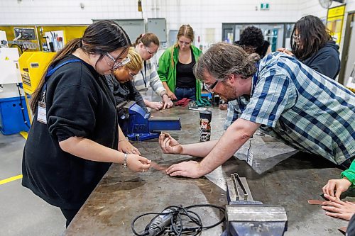MIKE DEAL / FREE PRESS
Autmnlee (left) shows Patrick Taggart (right), Instructional assistant in the Industrial Mechanic / Millwright program her the progress making a brass ring during the MITT LauncHER into Trades event where women who are 18 and older have an opportunity to explore the trades at the MITT Henlow Bay campus.
251008 - Wednesday, October 08, 2025.