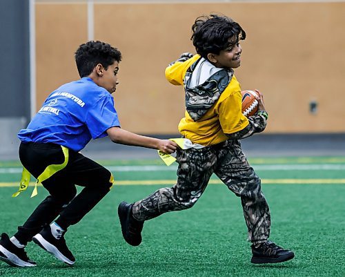 JOHN WOODS / FREE PRESS
Wasim, 10, right, participates with other new immigrant children in a free try flag football session at the University of Winnipeg Sunday, October 12, 2025. Football Manitoba held two sessions Sunday.

Reporter: ?