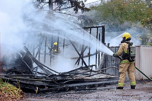 The fire consumed a garage and vehicle, setting off what witnesses described as small explosions. (Matt Goerzen/The Brandon Sun)