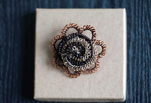 Ruth Bonneville / Free Press
49.8 - Creators
Photo of a brooch of a spiral flower made with hair.
Local artist, Sandra Klowak with Corporeal Curios, who creates artwork from hair, in her studio with samples of her work.
Story: Sandra Klowak creates artwork from hair for clients who donate hair of their loved ones who have died. It’s a form of sculpture which originated in the Victorian era.
Klowak has recently begun incorporating teeth – donated from friends and family members – into her personal artwork.
Oct 15, 2025