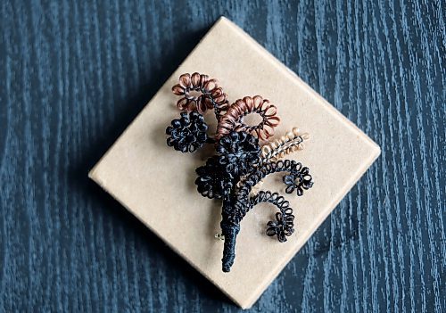 Ruth Bonneville / Free Press
49.8 - Creators
Photo of a flower arrangement created out of hair into a brooch.
Local artist, Sandra Klowak with Corporeal Curios, who creates artwork from hair, in her studio with samples of her work.
Story: Sandra Klowak creates artwork from hair for clients who donate hair of their loved ones who have died. It’s a form of sculpture which originated in the Victorian era.
Klowak has recently begun incorporating teeth – donated from friends and family members – into her personal artwork.
Oct 15, 2025