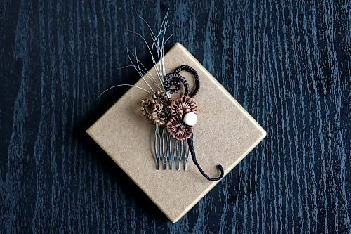 Ruth Bonneville / Free Press
49.8 - Creators
Photo of hair comb made with hair.
Local artist, Sandra Klowak with Corporeal Curios, who creates artwork from hair, in her studio with samples of her work.
Story: Sandra Klowak creates artwork from hair for clients who donate hair of their loved ones who have died. It’s a form of sculpture which originated in the Victorian era.
Klowak has recently begun incorporating teeth – donated from friends and family members – into her personal artwork.
Oct 15, 2025