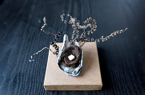 Ruth Bonneville / Free Press
49.8 - Creators
Photo of a mini sculpture made with hair, oyster shell and a tooth.
Local artist, Sandra Klowak with Corporeal Curios, who creates artwork from hair, in her studio with samples of her work.
Story: Sandra Klowak creates artwork from hair for clients who donate hair of their loved ones who have died. It’s a form of sculpture which originated in the Victorian era.
Klowak has recently begun incorporating teeth – donated from friends and family members – into her personal artwork.
Oct 15, 2025