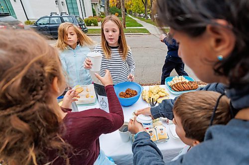 MIKE DEAL / FREE PRESS
Annie MacDonald (stripped shirt) prepares a drink for a customer at the corner of Waterloo Street and Kingsway.
Every Thursday morning since the beginning of September Jennie MacDonald&#x2019;s nine-year-old daughter Annie has been setting up a coffee stand on the corner of their street to raise money for CancerCare Manitoba.
Reporter: Eva Wasney
251016 - Thursday, October 16, 2025.
