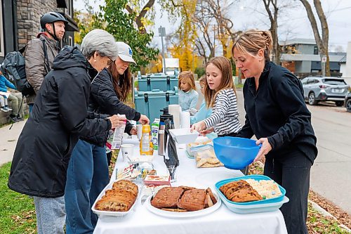 MIKE DEAL / FREE PRESS
Annie MacDonald (stripped shirt) with her mum, Jennie (right) help customers with their drinks and selection of treats that are available.
Every Thursday morning since the beginning of September Jennie MacDonald&#x2019;s nine-year-old daughter Annie has been setting up a coffee stand on the corner of their street to raise money for CancerCare Manitoba.
Reporter: Eva Wasney
251016 - Thursday, October 16, 2025.