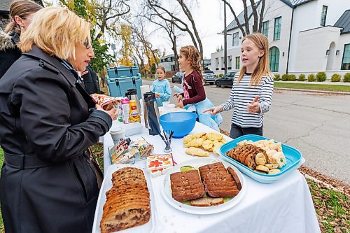 MIKE DEAL / FREE PRESS
Annie MacDonald helps a customer select a treat at the corner of Waterloo Street and Kingsway.
Every Thursday morning since the beginning of September Jennie MacDonald’s nine-year-old daughter Annie has been setting up a coffee stand on the corner of their street to raise money for CancerCare Manitoba.
Reporter: Eva Wasney
251016 - Thursday, October 16, 2025.