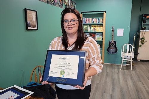 Earl Oxford School music teacher Erin Dodds shows her Brandon University Outstanding Young Alumni Award Monday afternoon. The award is presented annually by the BU Alumni Association to graduates aged 35 or younger who demonstrate leadership, dedication and positive impact in their professions or communities. (Abiola Odutola/The Brandon Sun)