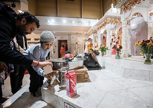 JOHN WOODS / FREE PRESS
Sandeep Sharma and his son Abhayjeet make offerings as people worship and make offerings during Diwali celebration Monday, October 20, 2025. Diwali is a celebration of the return of Rama after fourteen years in exile.

Reporter: ?