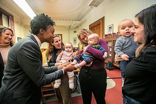 MIKAELA MACKENZIE / FREE PRESS
Health minister Uzoma Asagwara (left) chats with Hannah James (with nine-month-old Margaret Chenier), Brianna Boyse (with five-month-old Julien Croy), and Eleni Kirkikis (with eight-month-old Rudy Smith-Kirkikis) after announcing a new Manitoba parenting website on Wednesday, Oct. 22, 2025. 
For Chris Kitching story.
Free Press 2025