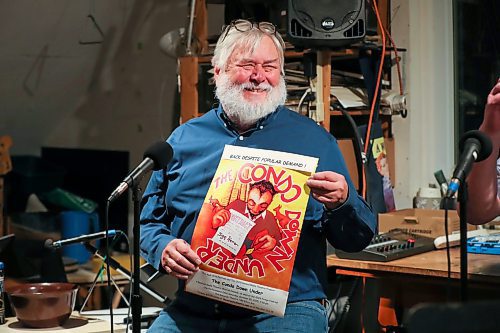 BROOK JONES/FREE PRESS
The Audi Arts Festival and The Old Elmwood Radio Theatre will be presenting The Condo Down Under at The Gargoyle Theatre at 585 Elice Ave. on Saturday, Oct. 25. Writer Stephen Gillies, 72, is pictured smiling while holding a promotional poster during a rehearsal at his home studio in Winnipeg, Man., Tuesday, Oct. 21, 2025.
